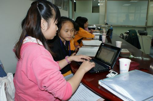 Students using mini-laptop to type report (1)