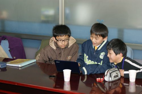 Students using mini-laptop to type report (2)