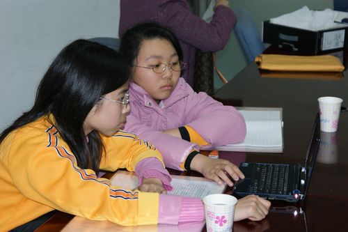 Students using mini-laptop to type report (3)