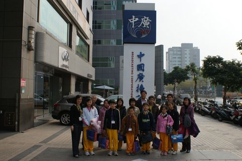 Team members taking a photo in front of the BCC HQ Songjian Building