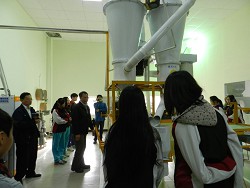 The students are concentrated on learning the cereal milling process.